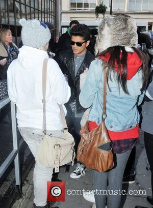 Bruno Mars signs autographs for fans  as he arrives at the BBC Radio One studios London, England - 19.01.11