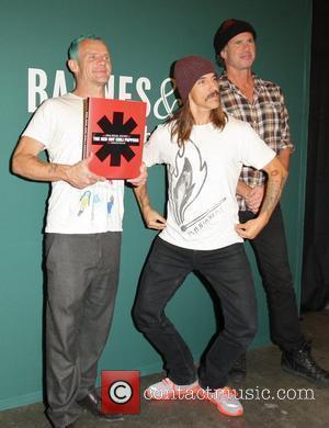 Flea aka Michael Peter Balzary, Anthony Kiedis and Chad Smith Red Hot Chili Peppers promote their new book 'The Red...