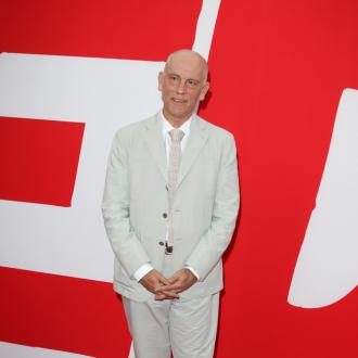 John Malkovich draws fashion designs while on set