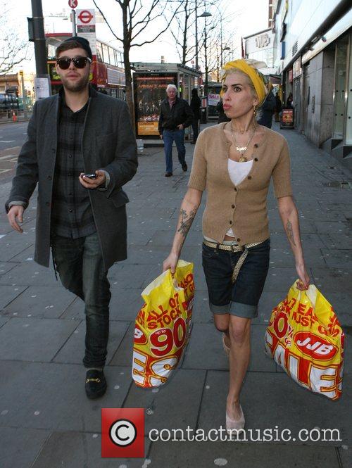 Amy Winehouse, Singer Friend Daniel Merriweather Indulge In Some Retail Therapy. Amy Spent Time Shopping In A Petrol Garage For Newspapers, A Sports Shop For Trainers, A Pharmacy For Make-up, A Fast Food Shop For Some Fried Chicken and Posing For Pictures With Fans Along The Way.