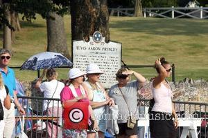 Fans have been walking up the Graceland Mansion's drive to visit Elvis Presley's grave, holding a candle each to pay...