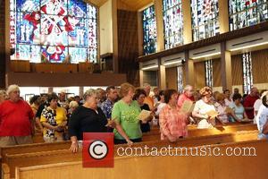 A mass is offered in memory of Elvis Presley at Saint Paul the Apostle Catholic Church. Fans have been walking...