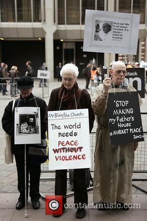 Protesters hold a placard outside Westminster cathedral Protestors were demonstrating against the continued military occupation of Iraq, while Tony Blair...