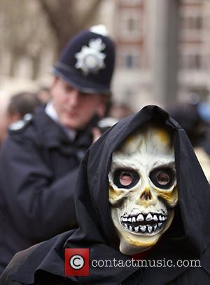 A protester wears a mask of a skull outside Westminster cathedral Protestors were demonstrating against the continued military occupation of...