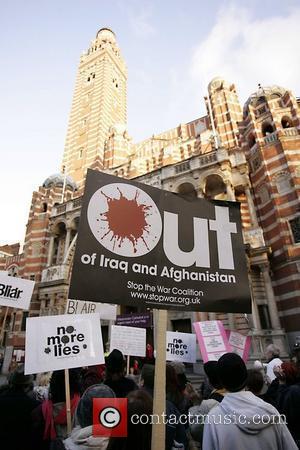 Protesters hold a placard outside Westminster cathedral Protestors were demonstrating against the continued military occupation of Iraq, while Tony Blair...