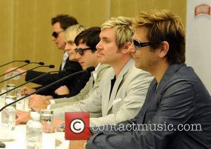 John Taylor, Nick Rhodes, Simon Le Bon and Andy Taylor of Duran Duran with Mark Ronson (c) at a press...