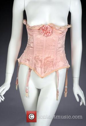 A Peach-colored bustier worn by Anna Nicole Smith in her centerfold shoot for Playboy issue May, 1996. The bustier comes...