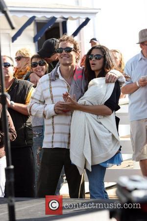 Matthew McConaughey, his girlfriend Camila Alves and their son Levi at the Surfrider Art and Music Festival on Malibu Pier....