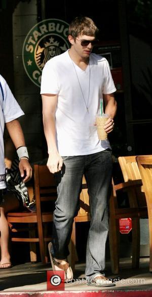 Ashton Kutcher stops by Starbucks coffee in Beverly Glen Market with a friend to pick up a Frappuccino. Los Angeles,...