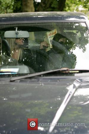 Boy George aka George O'Dowd leaves his home holding a copy of 'All About All About Eve' to cover his...