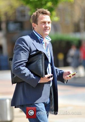 Bradley Walsh checking his phone while leaving the ITV studios London, England - 30.04.09