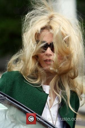Claudia Schiffer with windswept hair makes her way home after taking her children to school London, England - 12.05.09