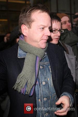 Kiefer Sutherland signs autographs for waiting fans as he leaves BBC Radio 1 after giving an interview on the Chris...