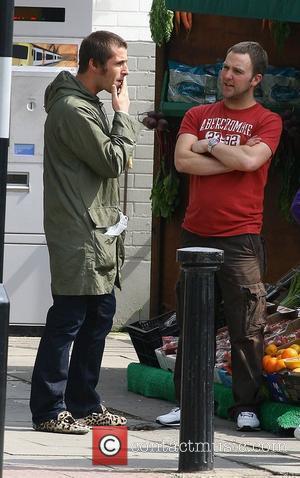 Liam Gallagher stops to talk to a member of the public whilst out with Nicole Appleton out in London with...