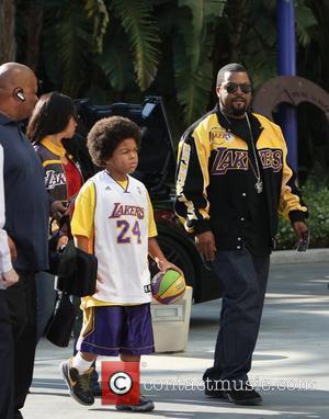 Ice Cube and Family arriving at the first game of the NBA National Championship Tournament between the L.A. Lakers and...