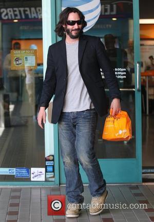 Keanu Reeves shopping at an AT&T store for a new cellphone while sporting a bushy beard Los Angeles, California -...