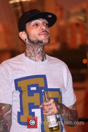 Travis McCoy relaxes backstage Paper Magazine and Ray-Ban present 'Sounds Like Paper' at the South Street Seaport New York City,...