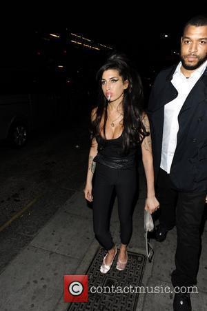 Amy Winehouse smokes a cigarette outside a pub in Camden London, England - 02.07.10