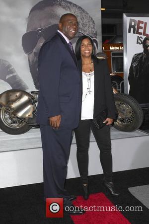 Magic Johnson with wife Cookie Johnson  Los Angeles Premiere of 'The Book Of Eli' held at the Grauman's Chinese...