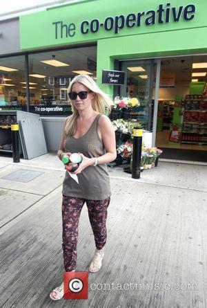 Denise van Outen  buys some drinks at a petrol station after filling up her car in North London London,...