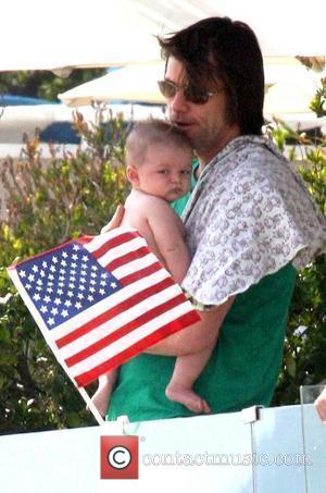 Jim Carrey holding his grandson Jackson Santana on Malibu Beach Malibu, California - 04.07.10