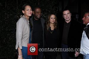 Kelly Preston and John Travolta posing for photos outside Mr Chow restaurant with Forest Whitaker and his wife Keisha Nash...