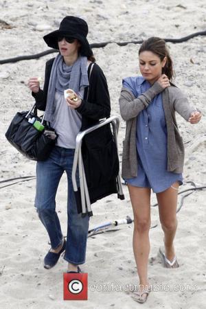Mila Kunis and cast member filming 'Friends with Benefits' on location at a beach  Los Angeles, California - 07.09.10