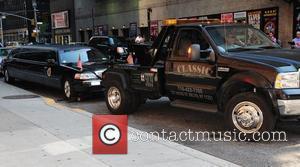 A Tow truck removes a limousine which displays the seal of the president of the united states outside The Ed...