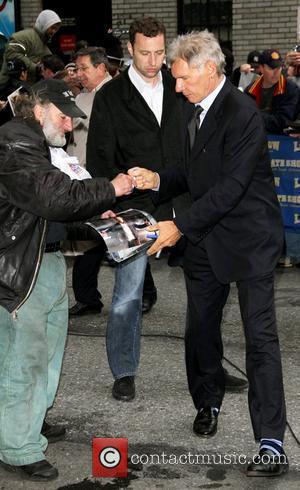 Harrison Ford gives an autograph to Radioman aka Craig Schwartz outside the Ed Sullivan theatre for The Late Show New...