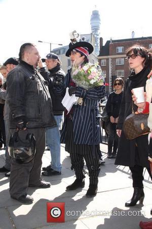 Adam Ant aka Stuart Goddard chats to mourners outside the Holy Trinity Church in Marylebone before a funeral service for...