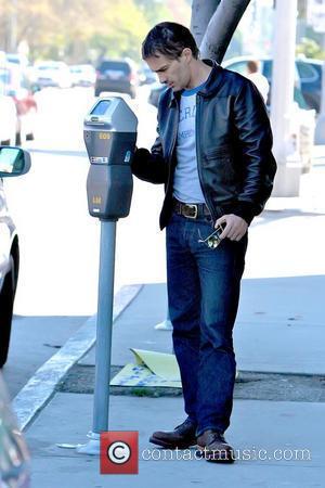 Olivier Martinez feeding a parking meter while out running errands Los Angeles, California - 09.10.10