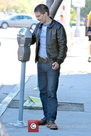 Olivier Martinez feeding a parking meter while out running errands Los Angeles, California - 09.10.10