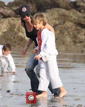 Victoria Beckham and Romeo Beckham running on the beach Malibu, USA - 31.01.10