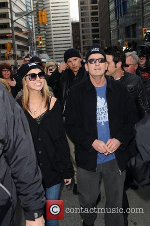 Charlie Sheen and his goddess Natalie Kenly leave his hotel and walk to Massey Hall as part of his...