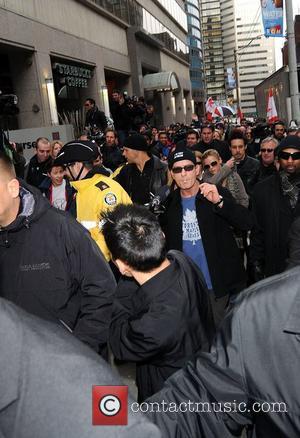 Charlie Sheen  leaves his hotel and walks to Massey Hall as part of his  BiPolar Awareness Walk during...