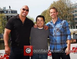 Dwayne Johnson, aka The Rock, Director, Justin Lin and Paul Walker attend a Photocall for Fast & Furious 5: Rio...
