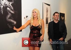 Brooke Hogan and Jordan Michael Zuniga attend a portrait unveiling at the Women In Cages exhibit at Cafeina Lounge Miami,...