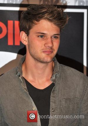 Jeremy Irvine poses for photographers before an 'Empire Big Screen' interview at the O2 Arena. London, England - 14.08.11