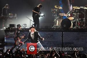 Guitarist/ songwriter Dj Ashba and Axl Rose of Guns N' Roses performs at the American Airlines Arena during his North...