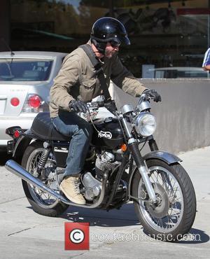 Keanu Reeves grabs a take away from Poquito Mass restaurant on his classic 1973 Norton Commando 750 motorcycyle Los Angeles,...