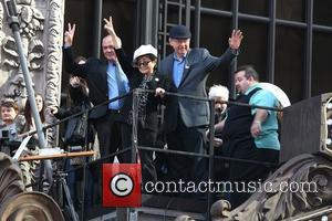 Hamish Dodds, Yoko Ono and Bill Ayres on top of the Hard Rock Cafe marquee as they launch the 'Imagine...