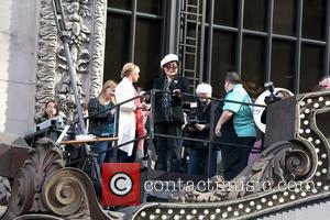 Yoko Ono on top of the Hard Rock Cafe marquee as they launch the 'Imagine There's No Hunger' campaign at...