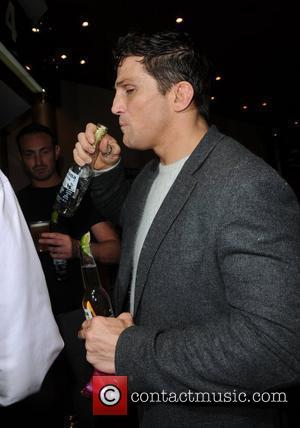 Alex Reid enjoys drinks from the free bar UK premiere of 'Zebra Crossing' at the Empire Leicester Square London, England...