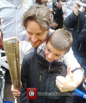 James McAvoy poses with a fan with the Olympic flame in Buchanan Street in Glasgow Glasgow, Scotland - 08.06.12