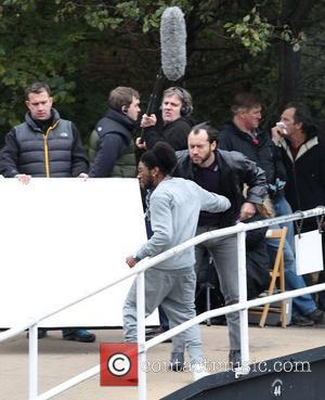 Jude Law gets punched  on the film set of 'Dom Hemingway' filming on location by a canal in East...