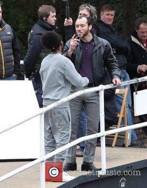 Jude Law  on the film set of 'Dom Hemingway' filming on location by a canal in East London London,...