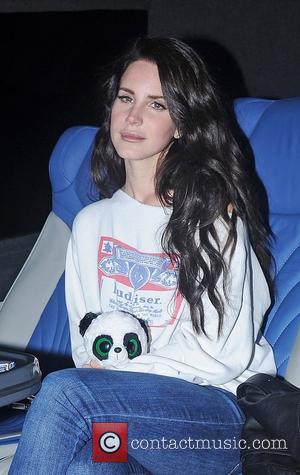 Lana Del Rey leaves Camden Roundhouse after performing at her iTunes gig wearing a Budweiser sweatshirt and holding a green...