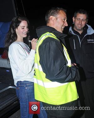 Lana Del Rey leaves Camden Roundhouse after performing at her iTunes gig. She autographed for fans including a fluorescent jacket....