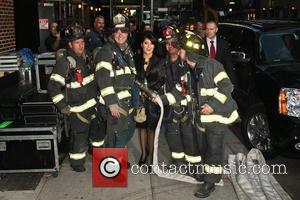 Salma Hayek poses with members of the FDNY 'The Late Show with David Letterman' held at the Ed Sullivan Theatre...