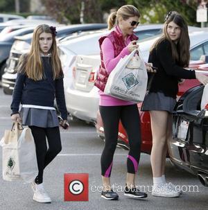 Lori Loughlin returns to her car with daughter's Isabella Rose and Olivia Jade after shopping at Bristol Farms Los Angeles,...